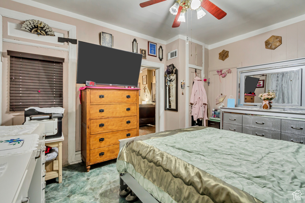 Bedroom featuring crown molding and a ceiling fan
