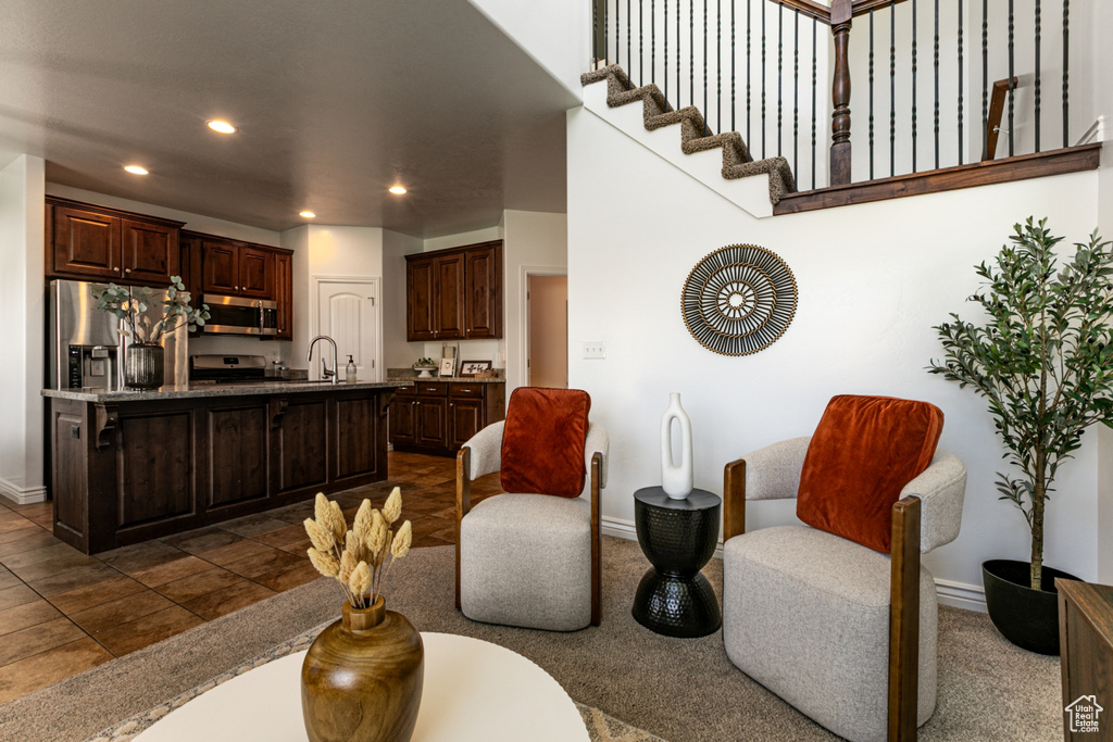 Living area featuring baseboards and recessed lighting