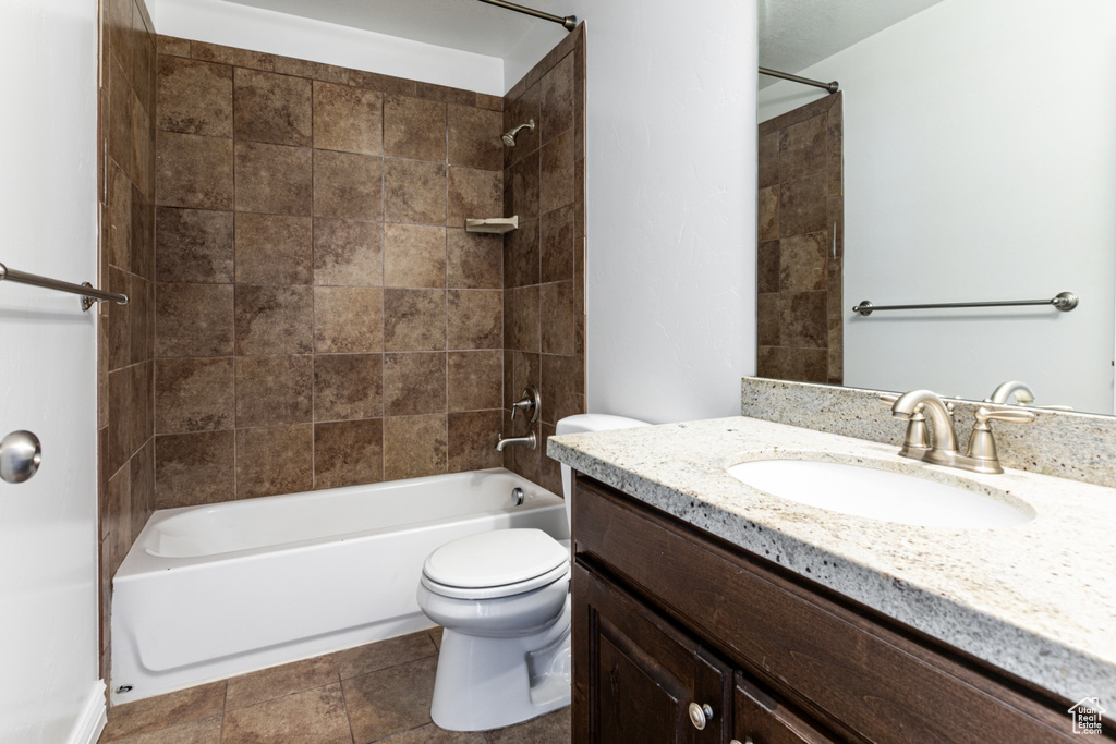 Bathroom with toilet, washtub / shower combination, and vanity
