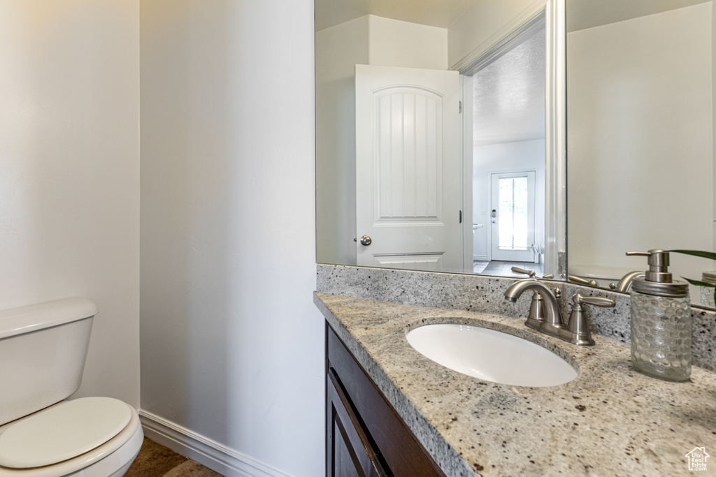 Half bathroom with toilet and vanity