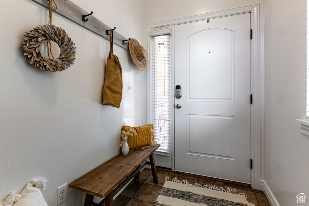 Mudroom featuring dark stone finish floors