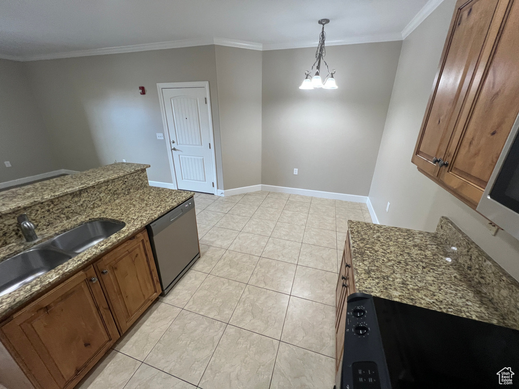Kitchen with dishwasher, a sink, brown cabinetry, ornamental molding, and dark stone countertops