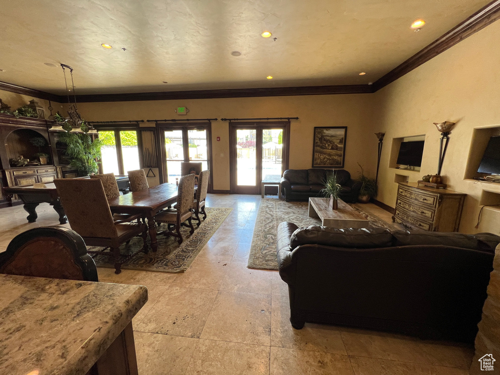 Living room featuring crown molding, plenty of natural light, french doors, recessed lighting, and baseboards