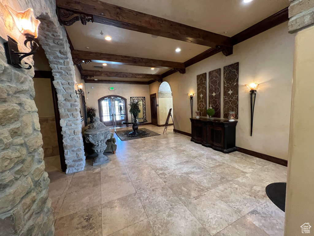 Building lobby with beam ceiling and recessed lighting