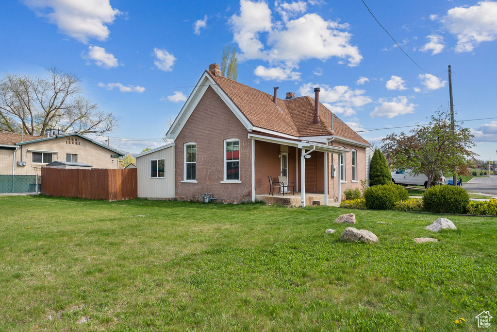Back of property with a chimney and brick siding