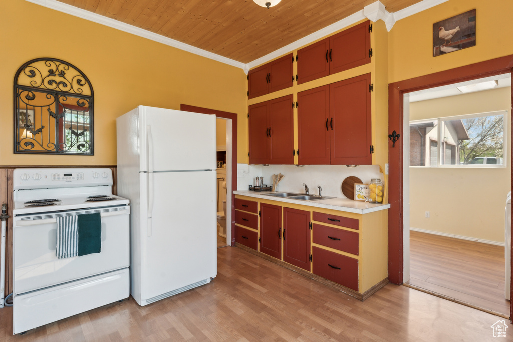 Kitchen featuring white appliances, wooden ceiling, crown molding, light countertops, and light wood-style flooring