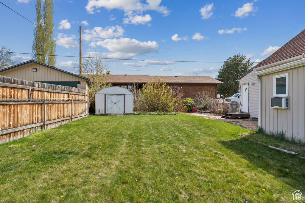 View of yard with a storage unit and an outdoor structure