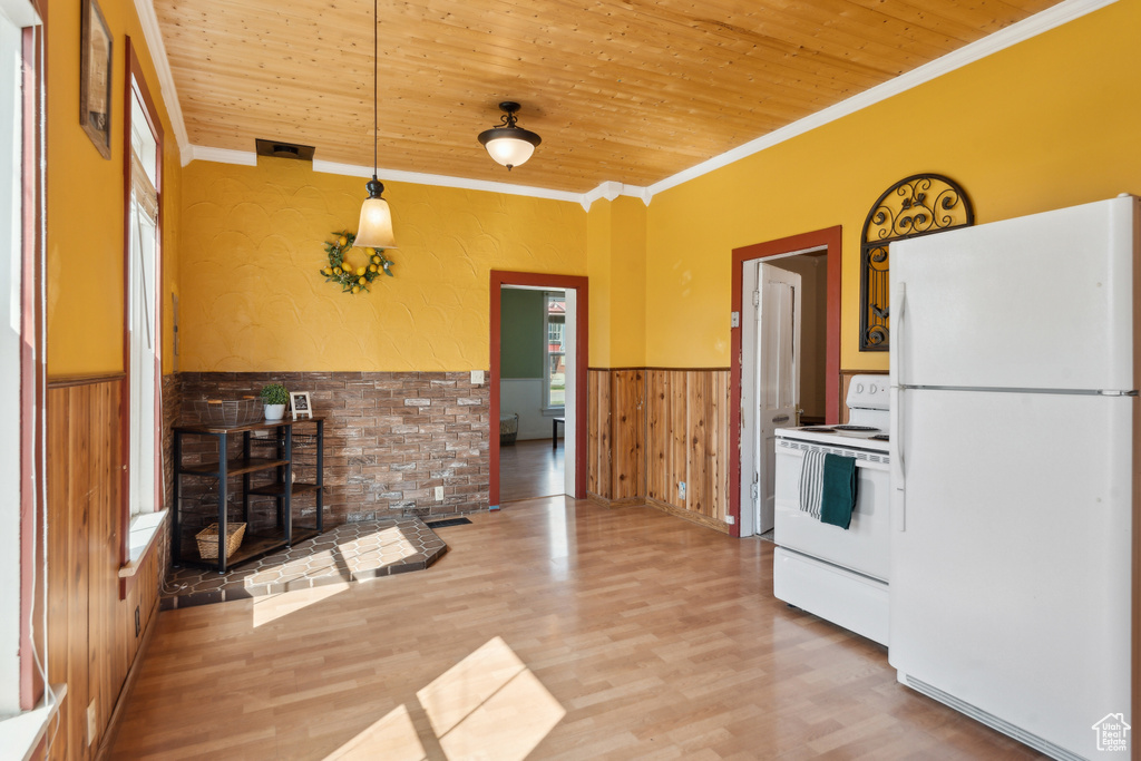 Kitchen featuring white appliances, wainscoting, wooden ceiling, ornamental molding, and light wood-style floors