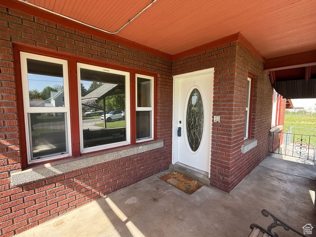 Entrance to property with brick siding