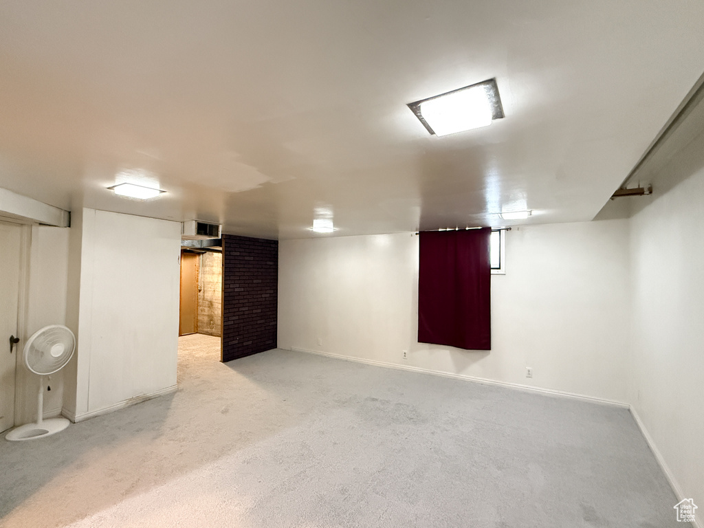 Finished below grade area featuring carpet flooring and baseboards
