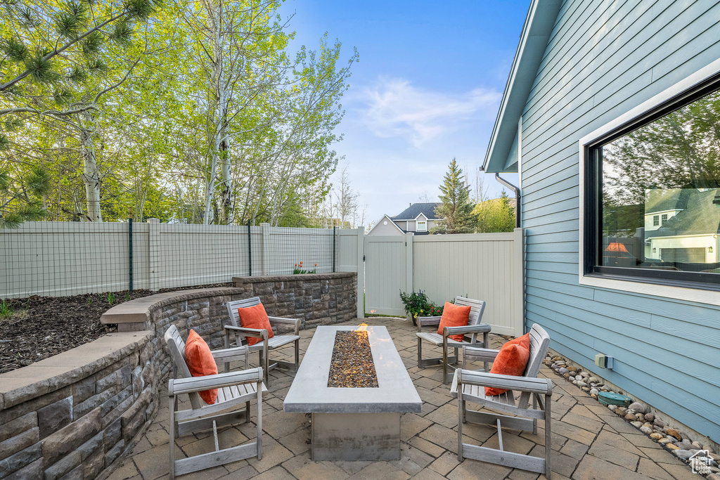 View of patio / terrace with a fire pit and a fenced backyard