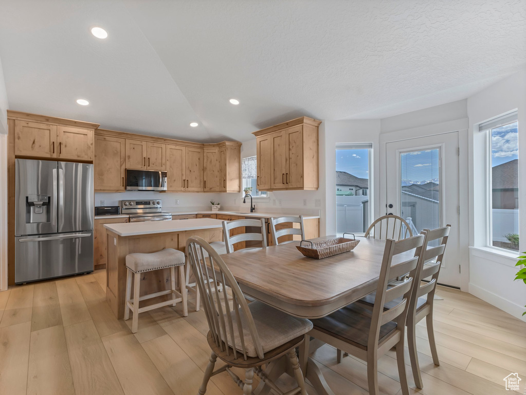Dining space with light wood-style flooring, healthy amount of natural light, recessed lighting, and separate washer and dryer