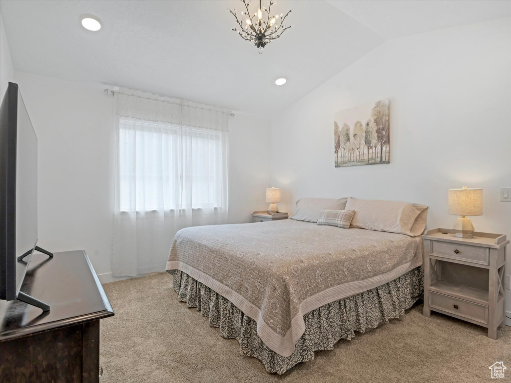 Bedroom featuring vaulted ceiling, carpet, a chandelier, recessed lighting, and baseboards