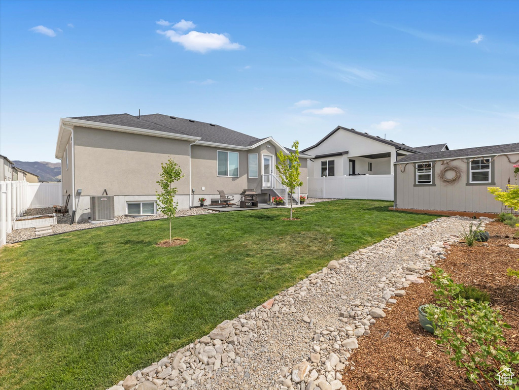 Back of house featuring a patio, stucco siding, central AC, and entry steps