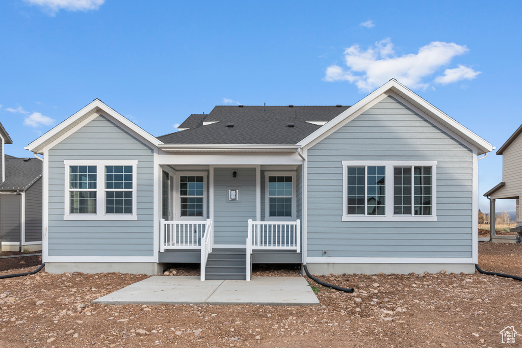Back of house featuring covered porch