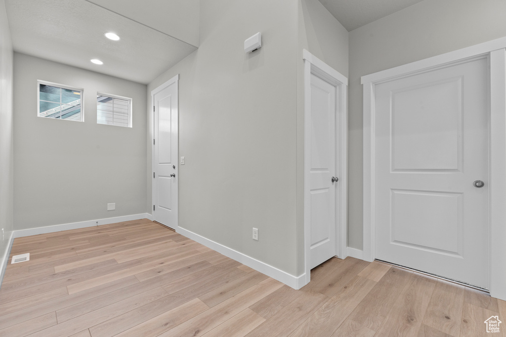 Foyer featuring light wood finished floors, baseboards, and recessed lighting