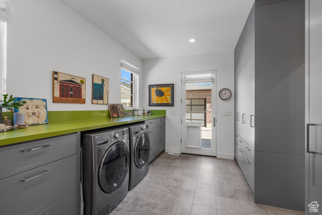 Laundry room featuring washing machine and clothes dryer, baseboards, and recessed lighting