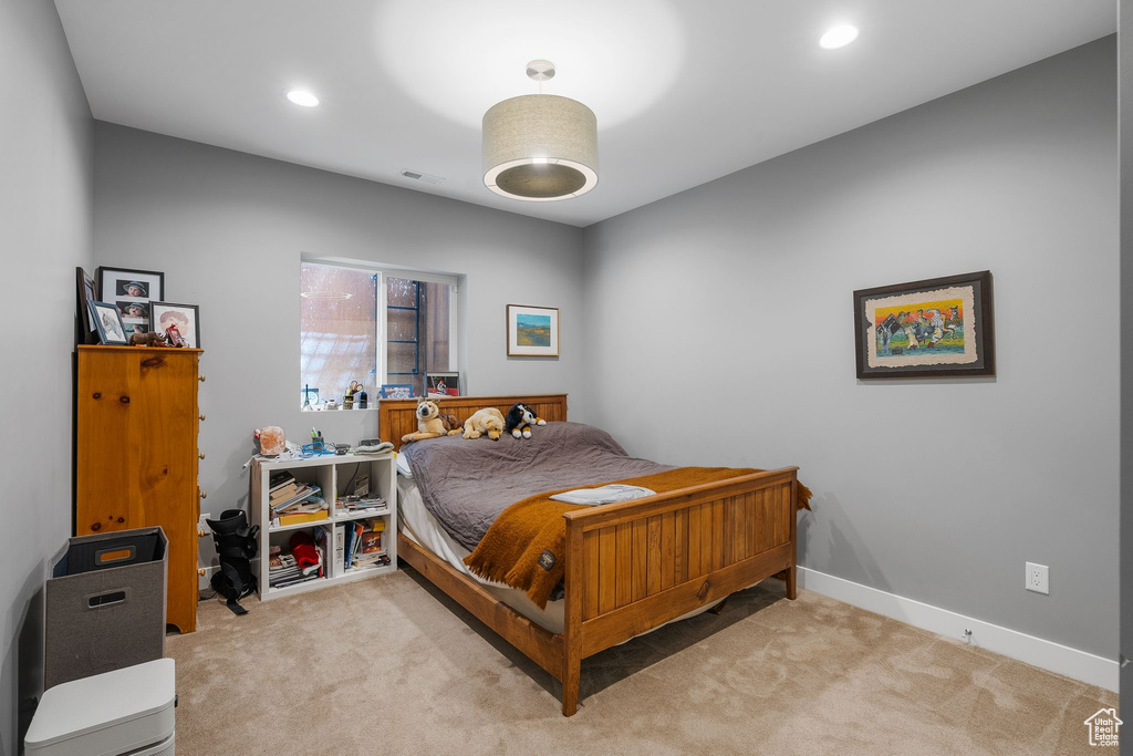Bedroom with light carpet, baseboards, and recessed lighting