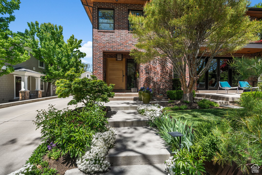 View of exterior entry featuring brick siding