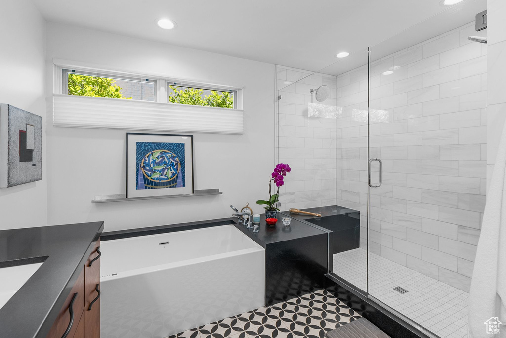 Full bath featuring recessed lighting, a stall shower, a tub, vanity, and tile patterned floors