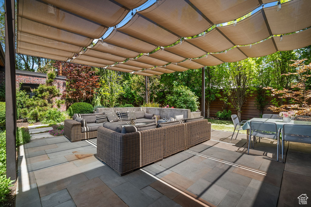 View of patio / terrace featuring an outdoor hangout area, outdoor dining space, a pergola, and fence