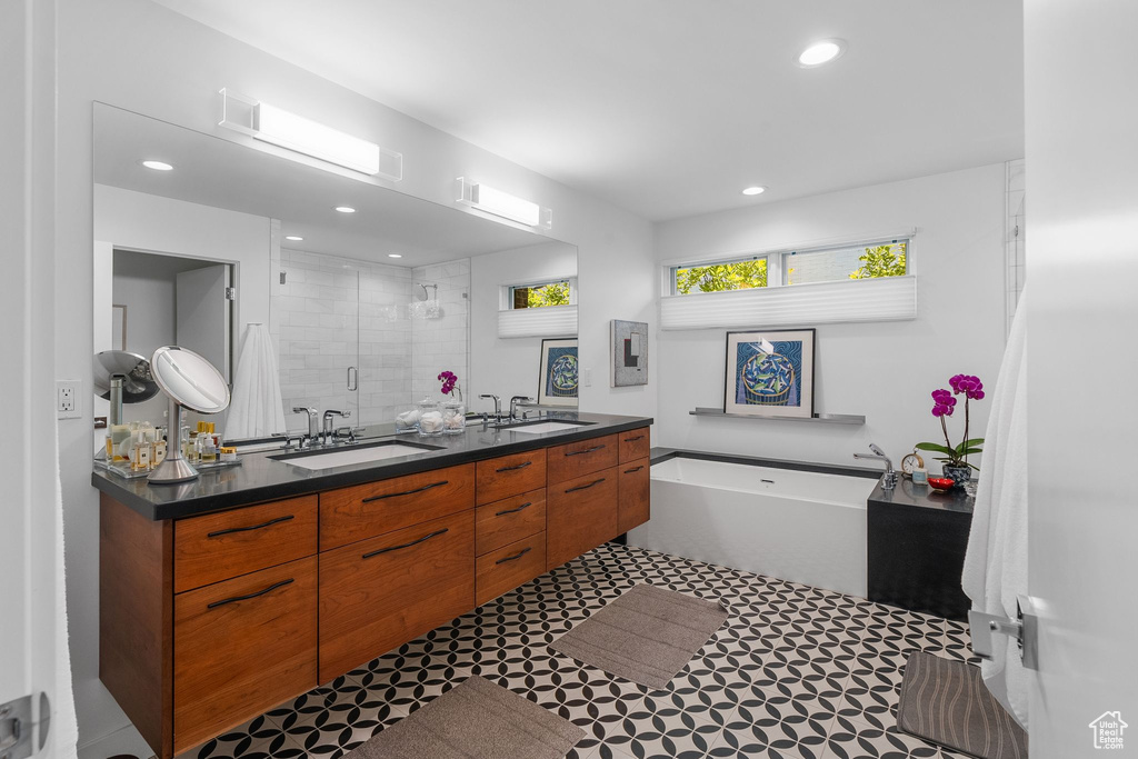 Full bath with a stall shower, double vanity, a garden tub, recessed lighting, and tile patterned floors