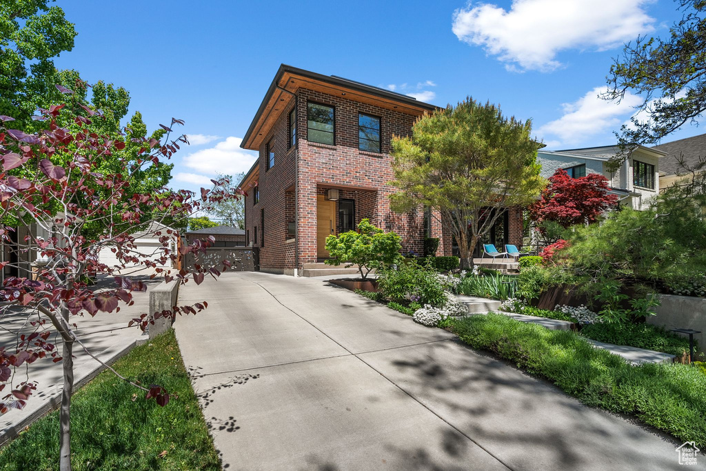 View of front of house with brick siding and driveway