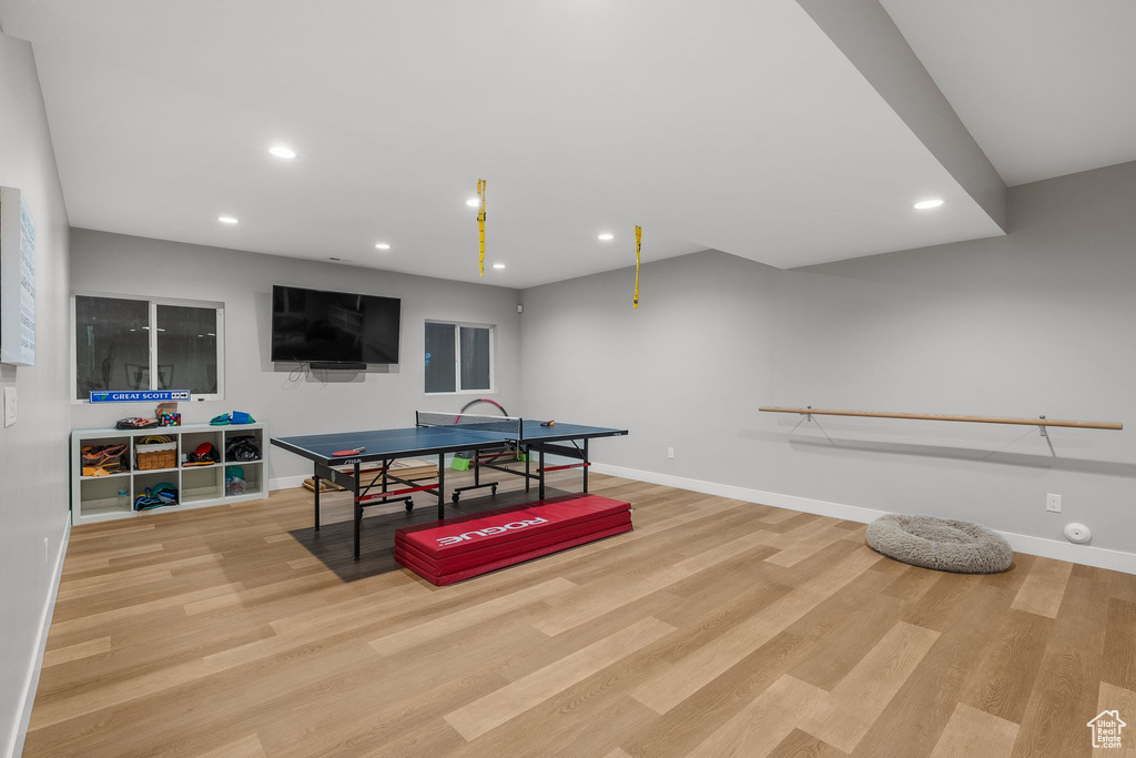 Game room with recessed lighting, wood finished floors, and baseboards