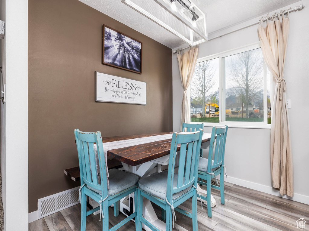 Dining space featuring baseboards and wood finished floors