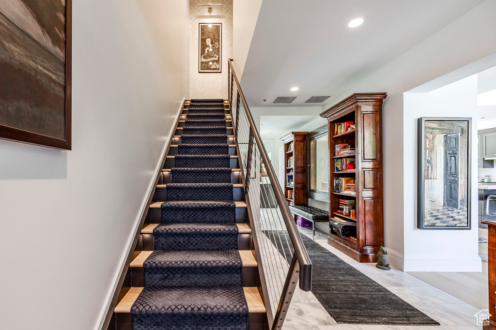 Stairway featuring recessed lighting and baseboards