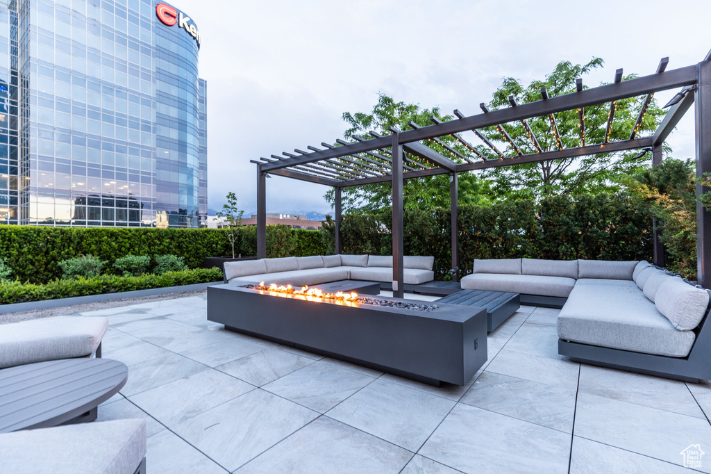 View of patio / terrace featuring an outdoor living space with a fire pit and a pergola