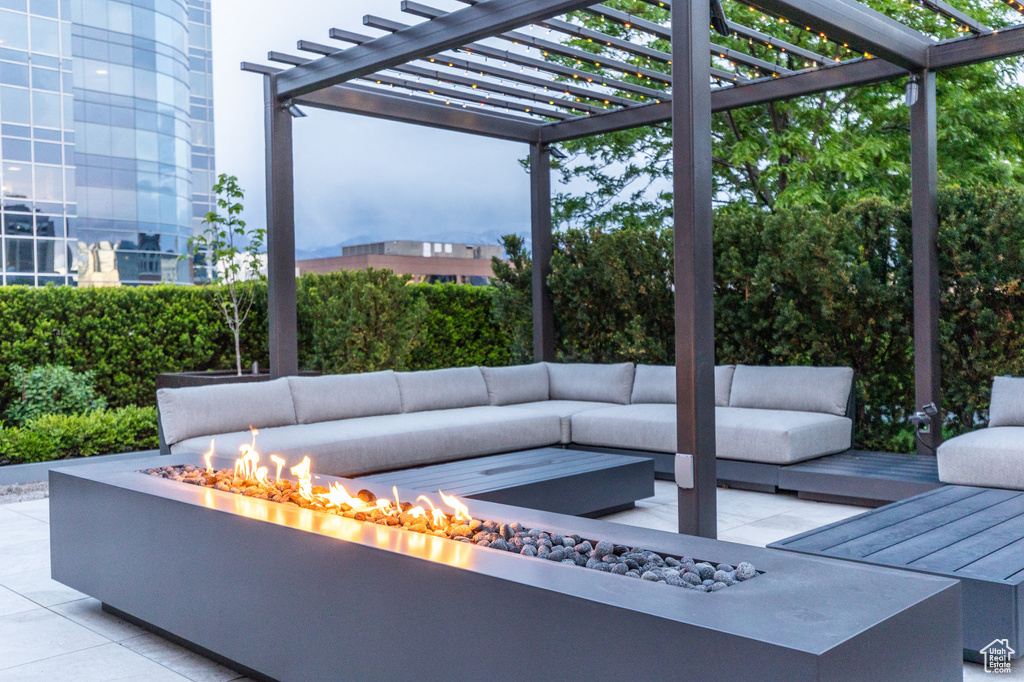 View of patio / terrace with an outdoor living space with a fire pit and a pergola