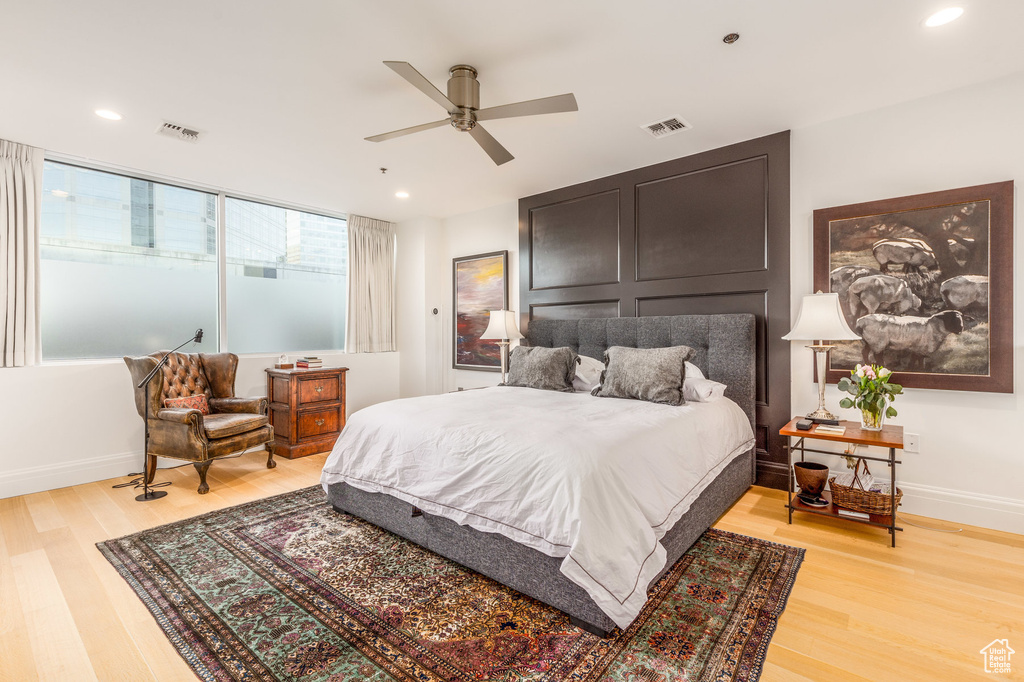 Bedroom featuring light wood finished floors, baseboards, recessed lighting, and a ceiling fan