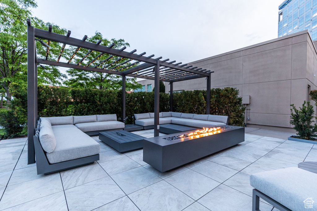 View of patio / terrace with an outdoor living space with a fire pit and a pergola