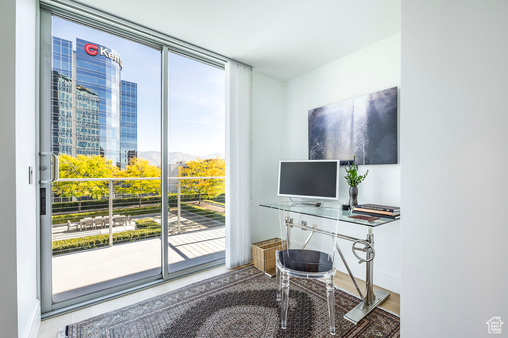 Office featuring plenty of natural light, expansive windows, and baseboards