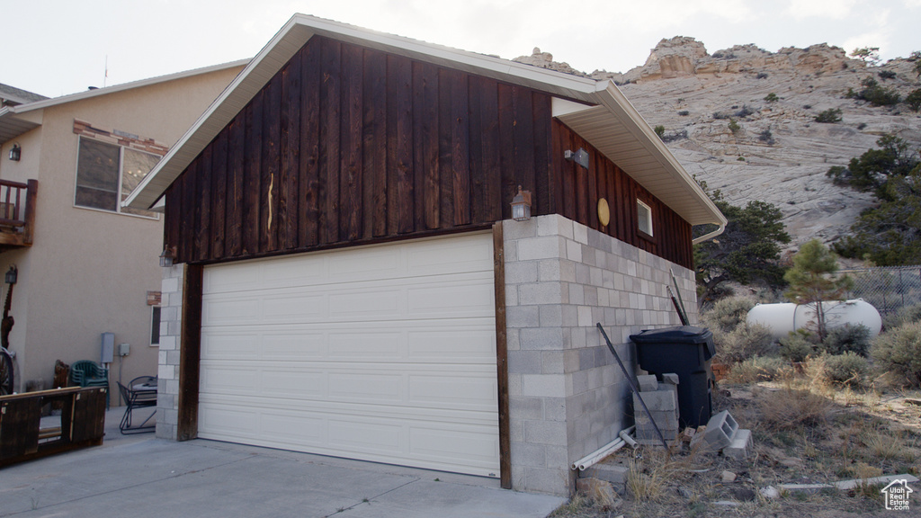 Garage featuring driveway and a mountain view