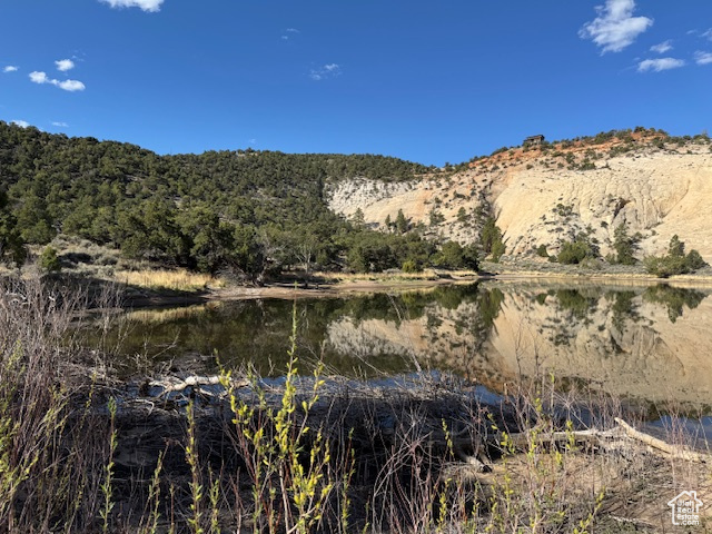 View of mountain backdrop featuring a nearby body of water