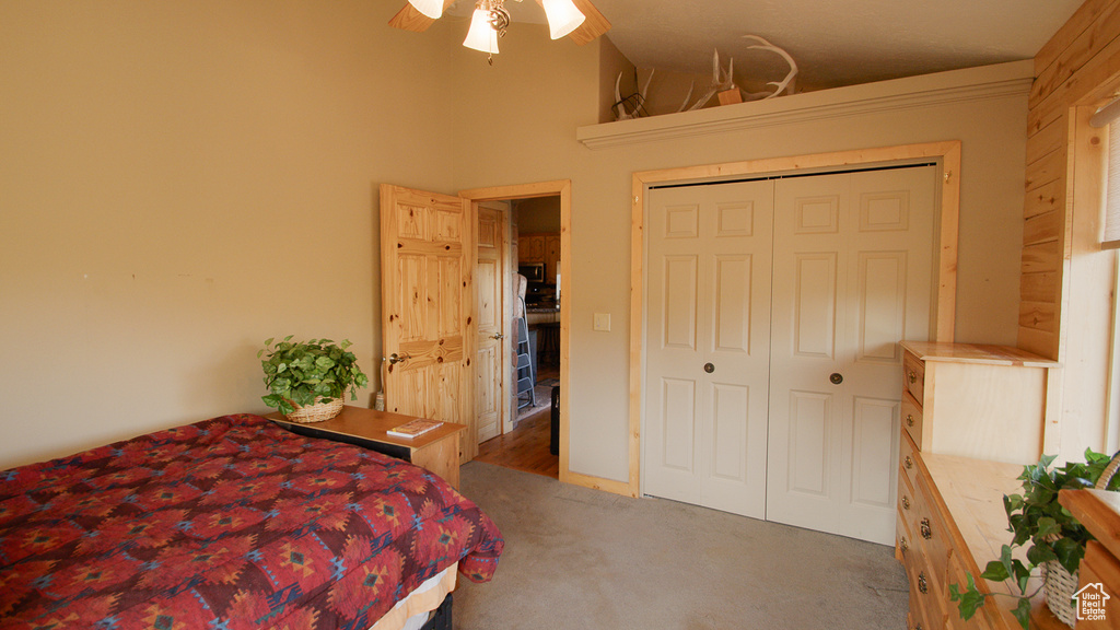 Bedroom with carpet, a ceiling fan, and a closet
