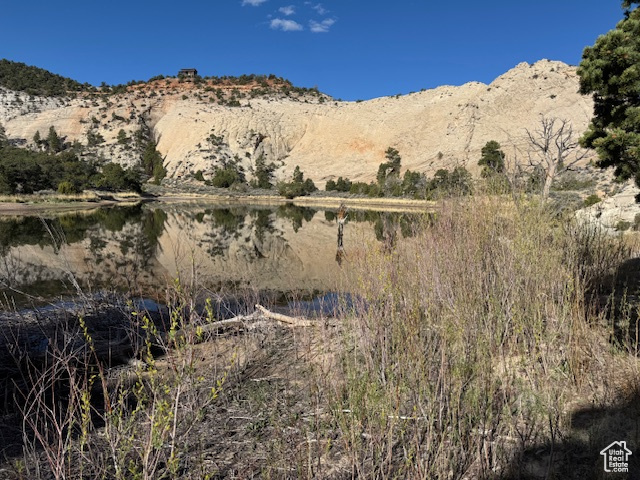 View of mountain backdrop featuring a nearby body of water