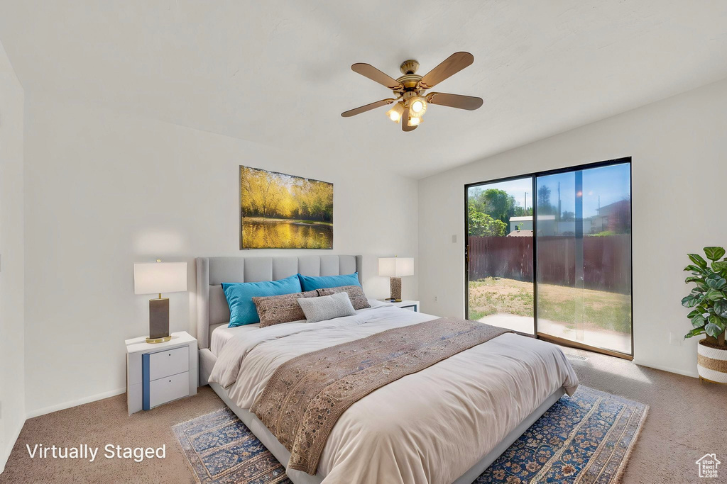 Bedroom featuring light colored carpet, access to exterior, lofted ceiling, baseboards, and a ceiling fan