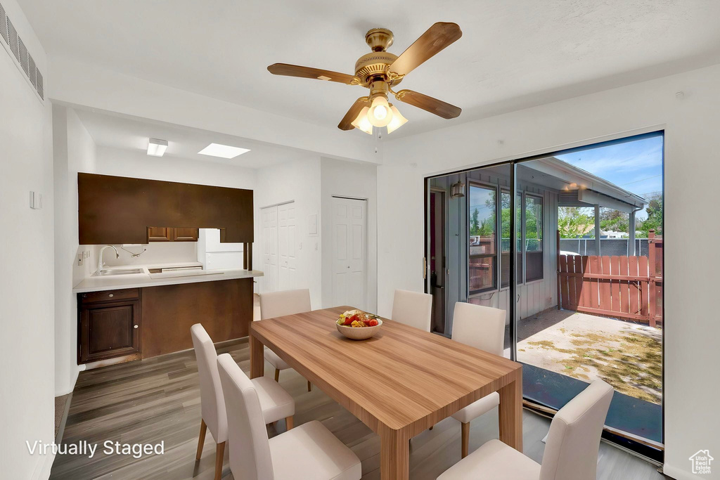 Dining area featuring ceiling fan and light wood-style flooring
