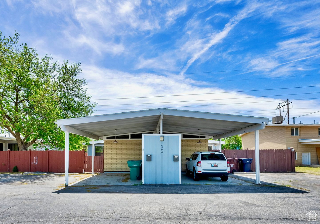 View of parking / parking lot featuring fence