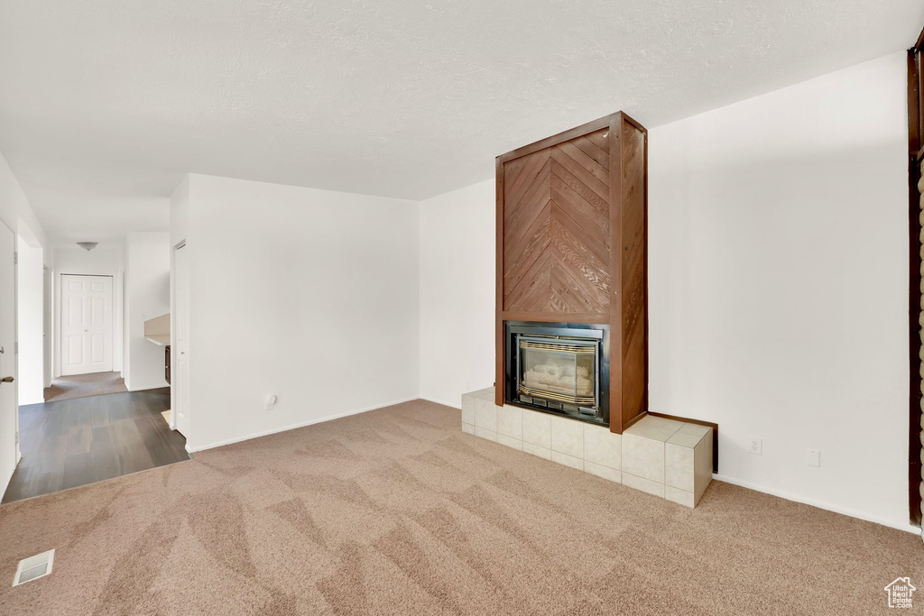 Unfurnished living room with carpet and baseboards