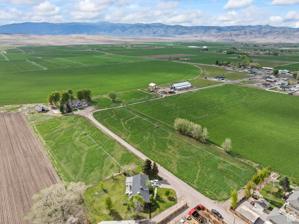 Aerial view of property's location featuring rural landscape and a mountainous background