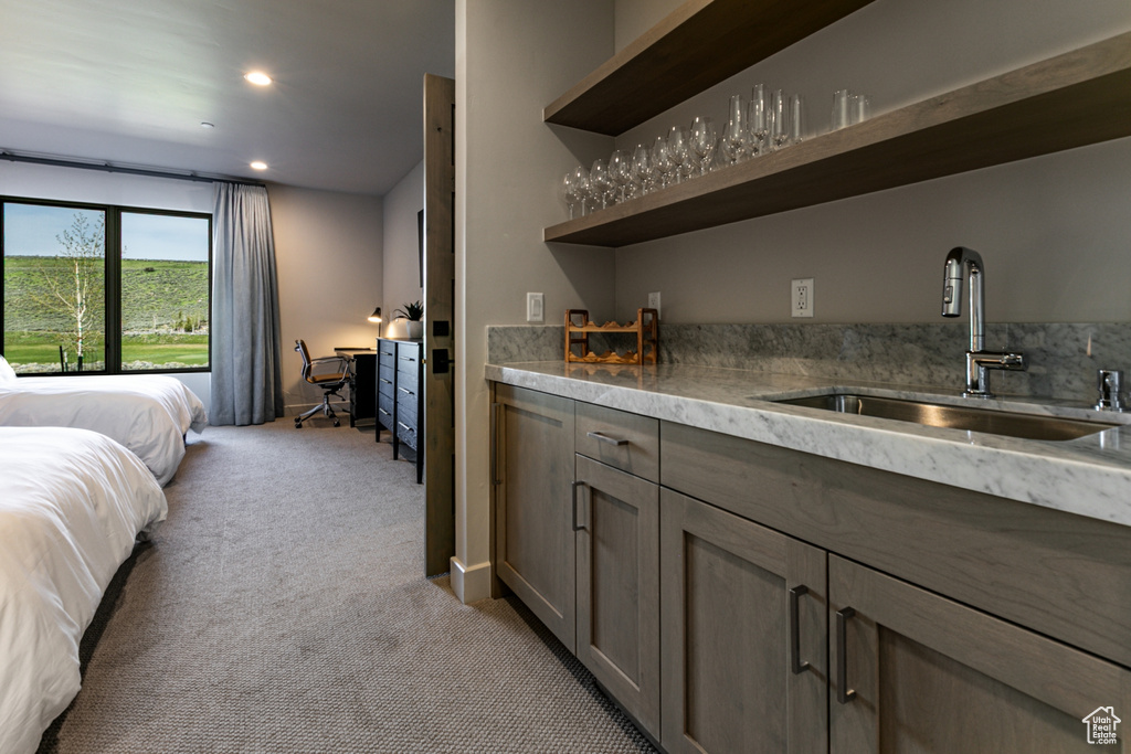 Indoor bar with light colored carpet and recessed lighting