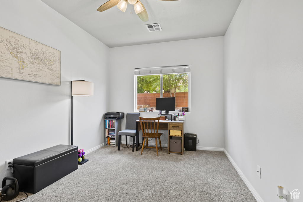 Office area featuring carpet floors, a ceiling fan, and baseboards
