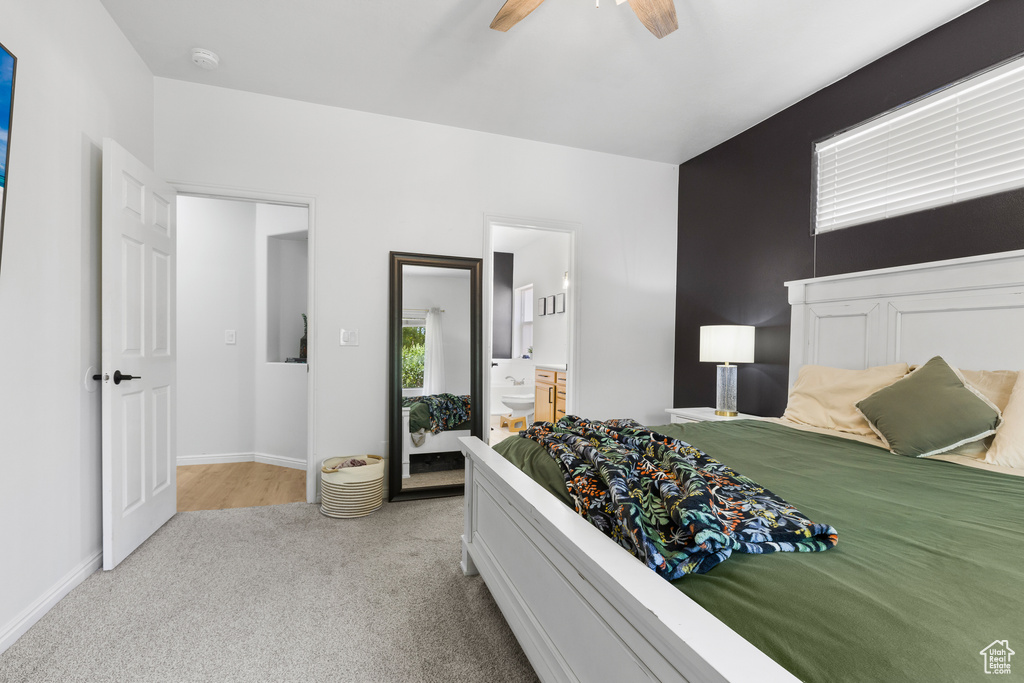 Bedroom featuring carpet, a ceiling fan, baseboards, and ensuite bath