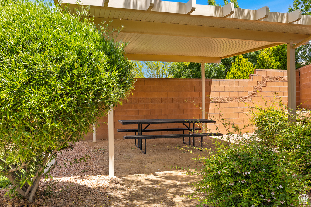 View of patio featuring fence