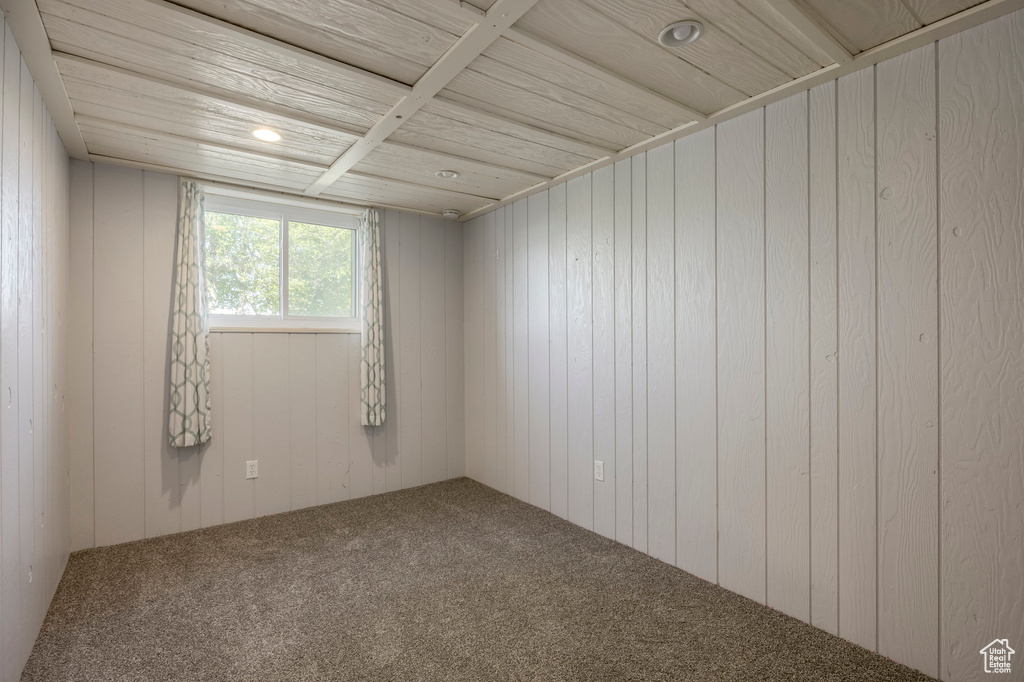 Spare room featuring carpet flooring, wood walls, wood ceiling, and recessed lighting