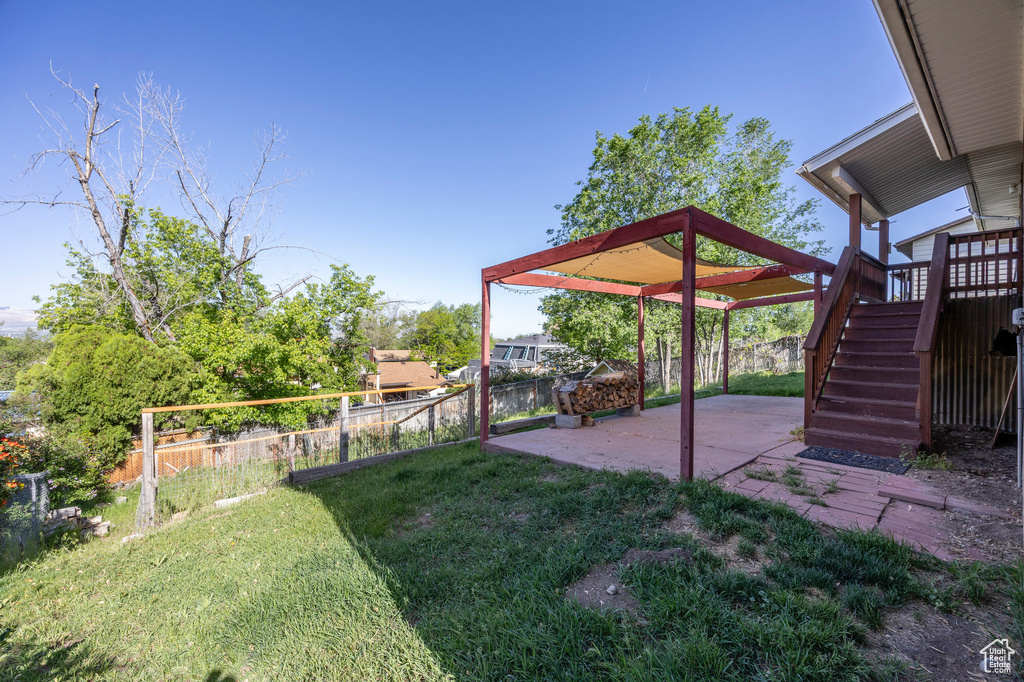 View of yard with a patio and stairs